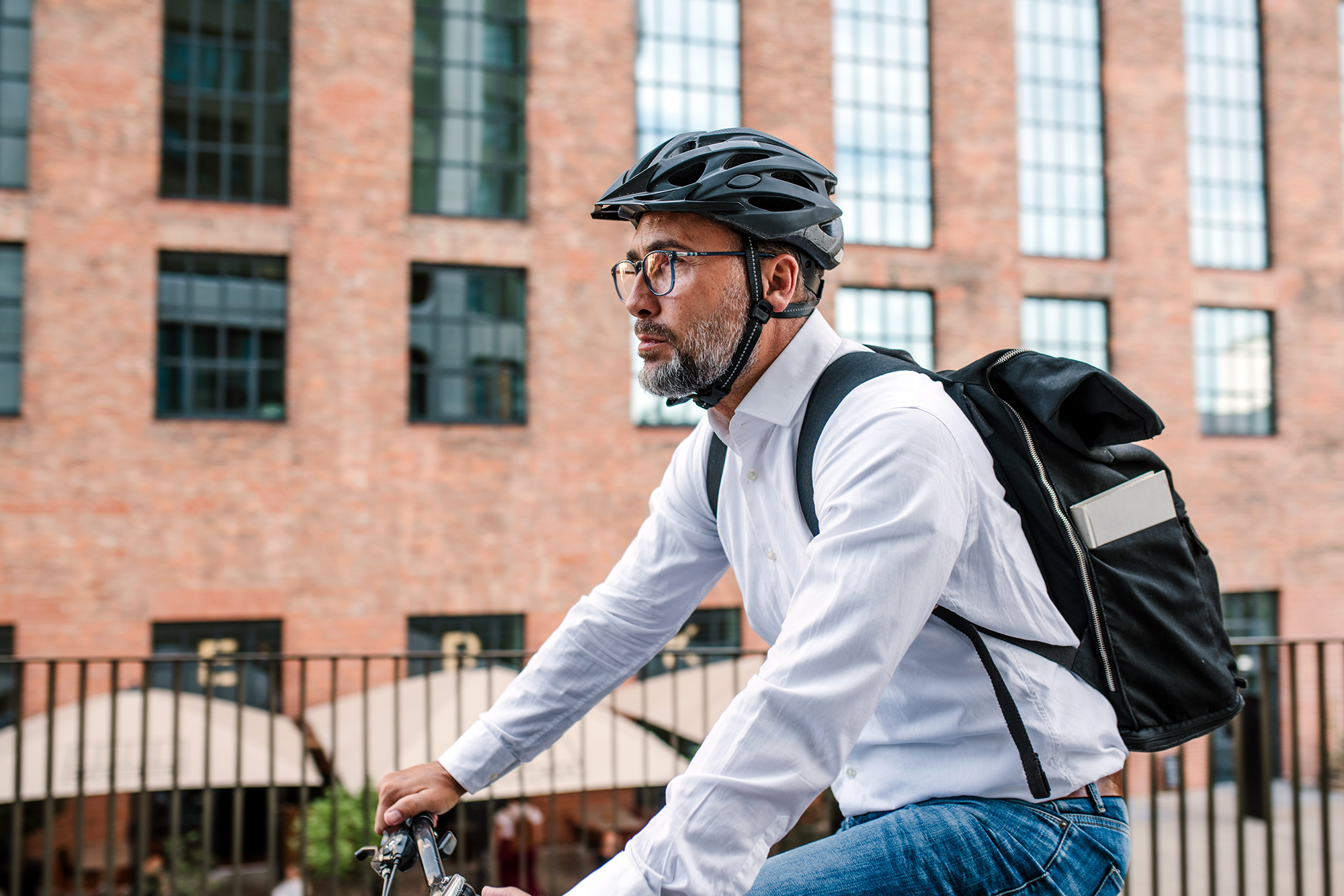 City,Commuter,Riding,Bike,To,Office,,Wearing,Backpack,And,Helmet.
